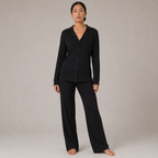 Model wearing the FitFigura Soft LoungeWear Set – Comfort Form in Onyx Black, featuring a long-sleeve button-up lounge top and relaxed wide-leg pants, front view.
