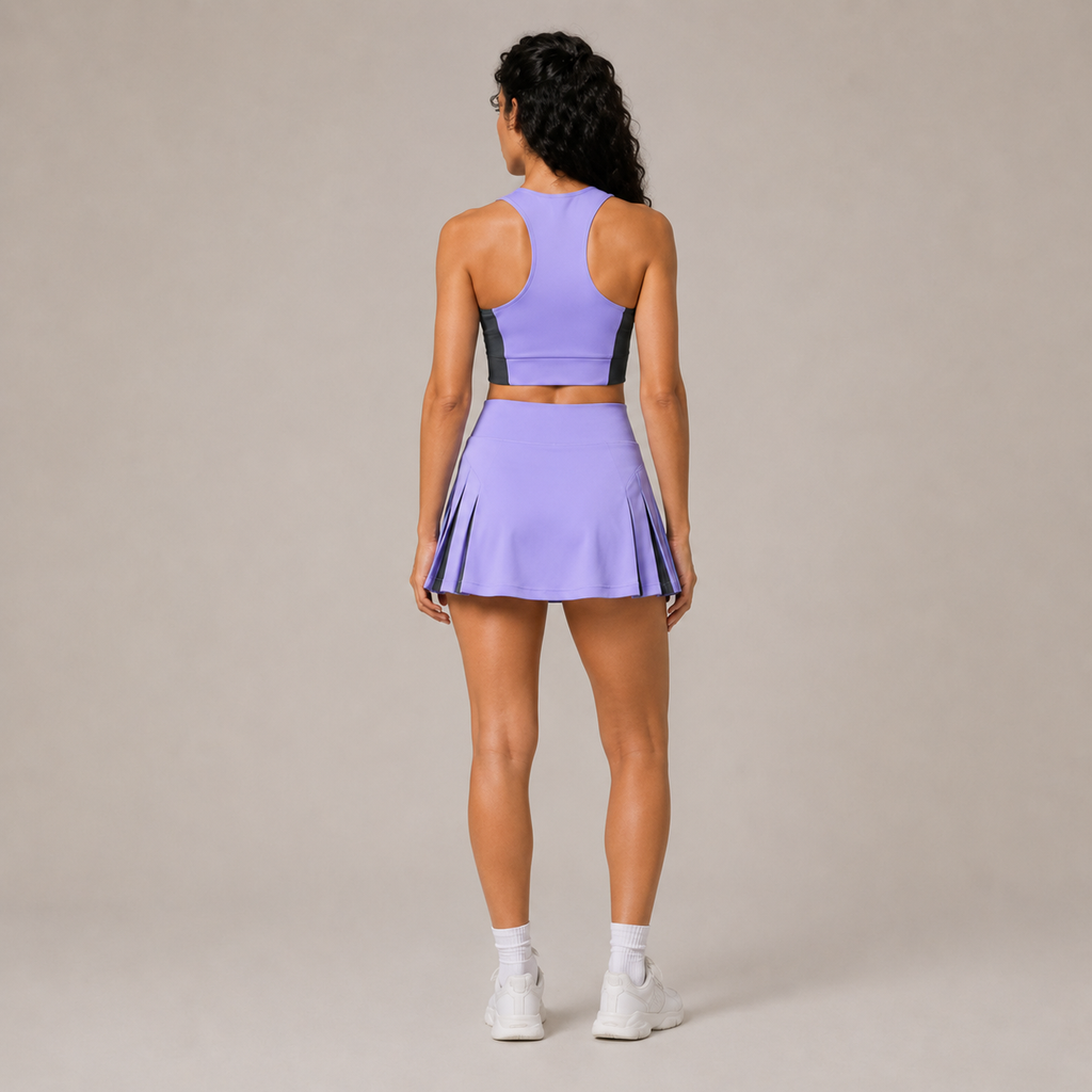 Back view of the Fitfigura Ace Motion Performance Set – Sculpt Match Form in light purple, showing the rear fit of the crop top and pleated skirt.