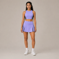 Model wearing the Fitfigura Ace Motion Performance Set – Sculpt Match Form in light purple, featuring a sleeveless crop top and matching pleated skirt, shown from the front.