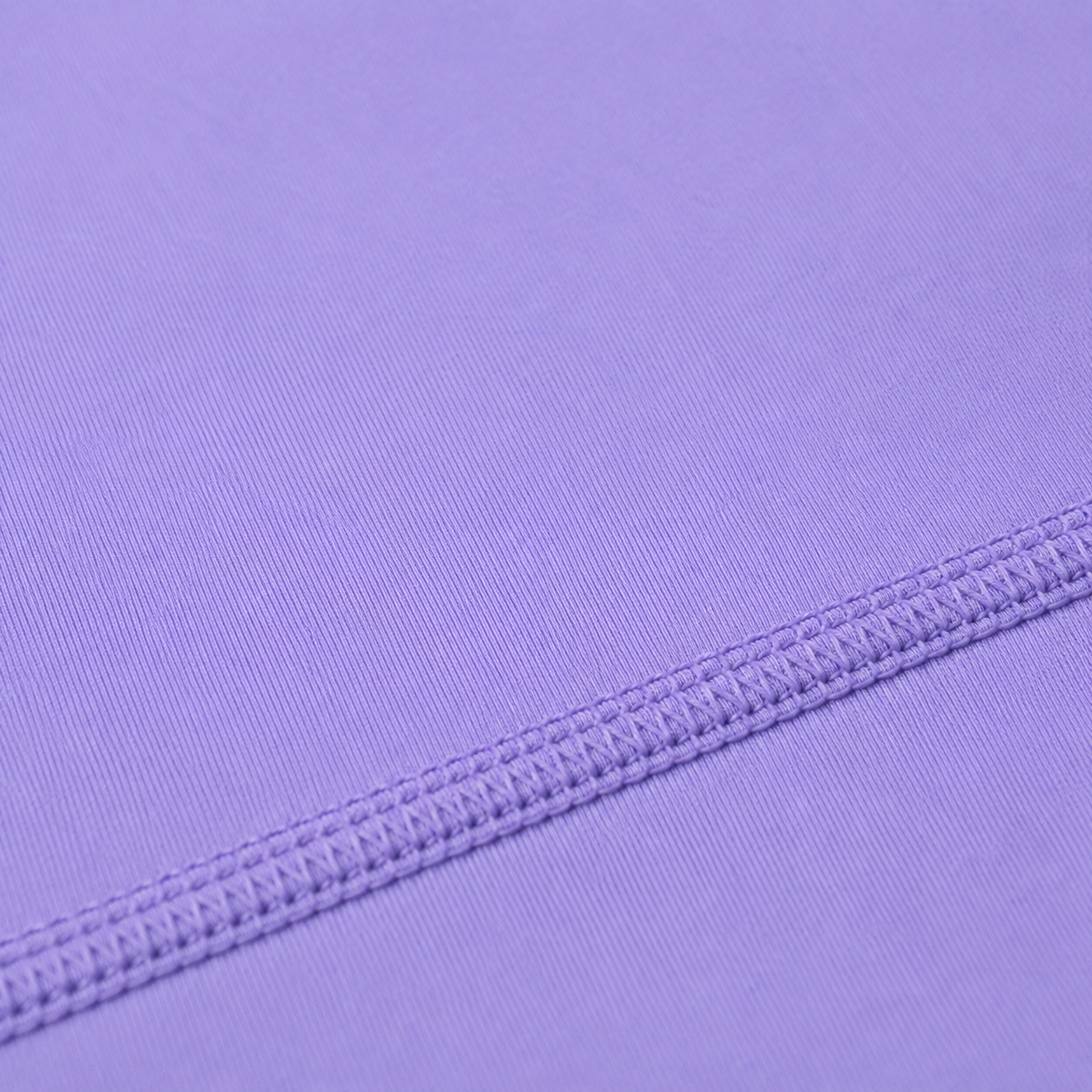 Close-up of the stitching and seam detail on the light purple Fitfigura Ace Motion Performance Set – Sculpt Match Form.