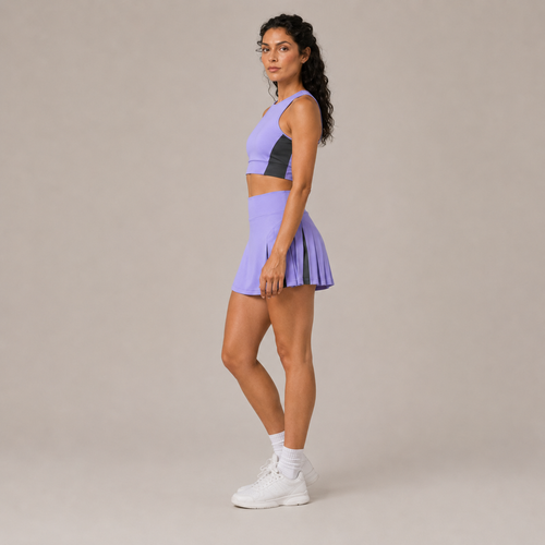 Side-angle studio view of the light purple Fitfigura Ace Motion Performance Set – Sculpt Match Form, showing the fitted crop top and pleated skirt.