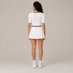 Back view of the white Fitfigura Ace Set – Signature Court Form, showing the rear fit of the top and the matching pleated skirt.