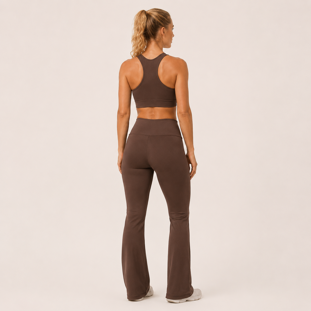 Back view of the brown Fitfigura Balance Flare Pant – Sculpt Silhouette, showing the fitted upper leg and flared lower silhouette.
