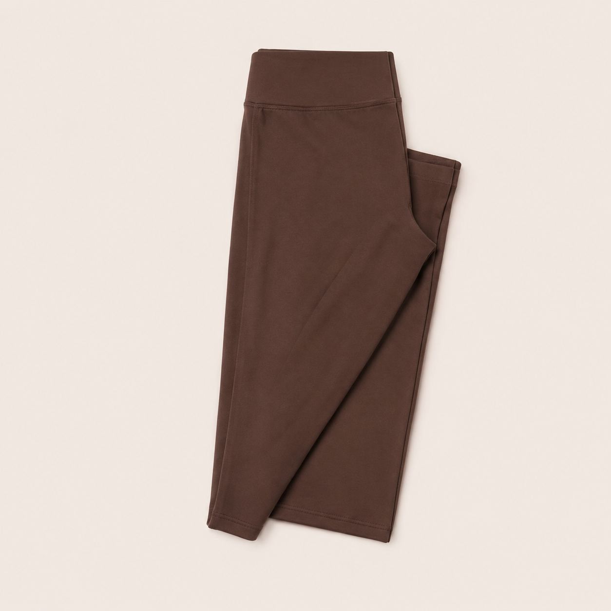 Flat lay of the Fitfigura Balance Flare Pant – Sculpt Silhouette in brown, folded to show the flared leg shape.