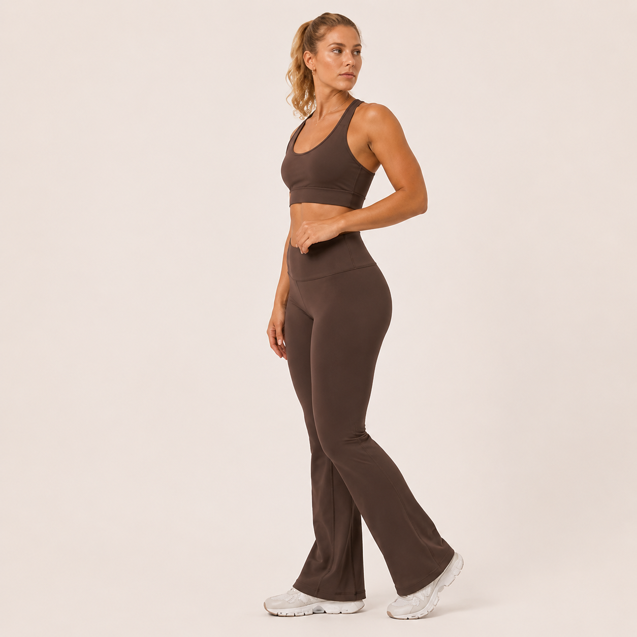 Side-angle view of the brown Fitfigura Balance Flare Pant – Sculpt Silhouette, showing the smooth fit through the hips and flared hem.