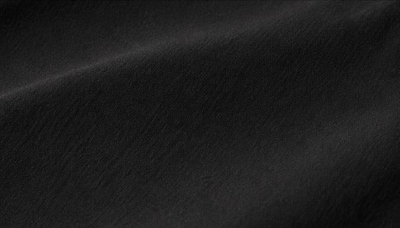 Close-up of the black fabric texture used in the Fitfigura Club Skirt – Luxe Resort Form.
