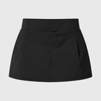 Flat lay of the Fitfigura Club Skirt – Luxe Resort Form in black, showing the skirt’s clean lines and compact resort-inspired silhouette.