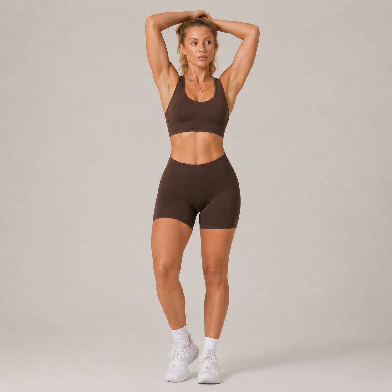 Model wearing the dark brown Fitfigura Contour Bra – Defined Sculpt with arms raised, highlighting the secure fit and sculpted activewear shape.