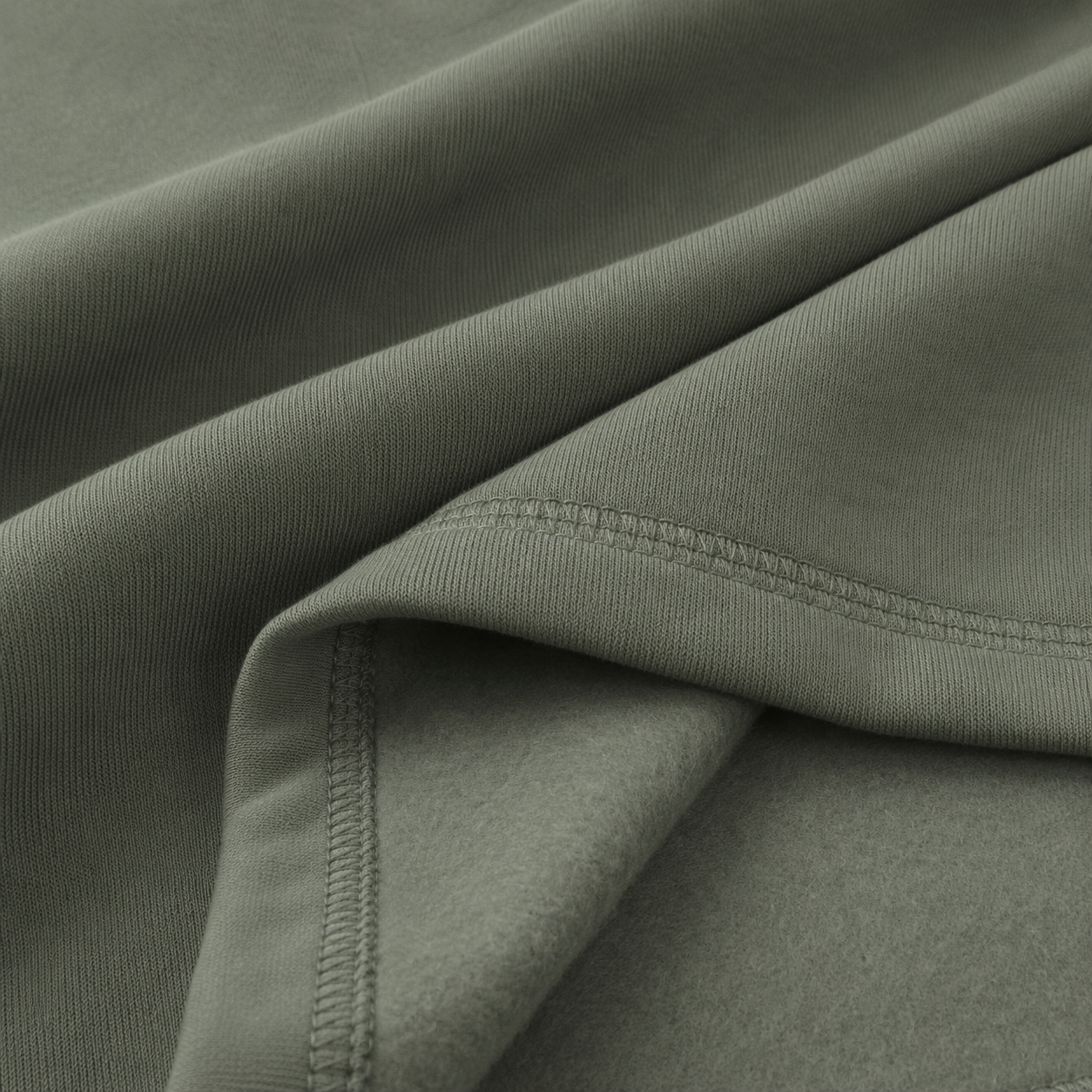 Close-up of the olive green fabric texture used in the Fitfigura Core Hoodie – Essential Form.