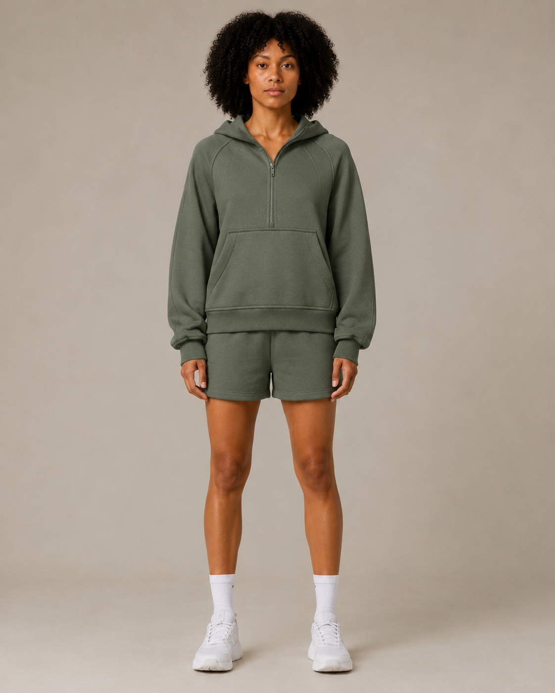 Model wearing the Fitfigura Core Hoodie – Essential Form in olive green with matching shorts and white socks, shown from the front.