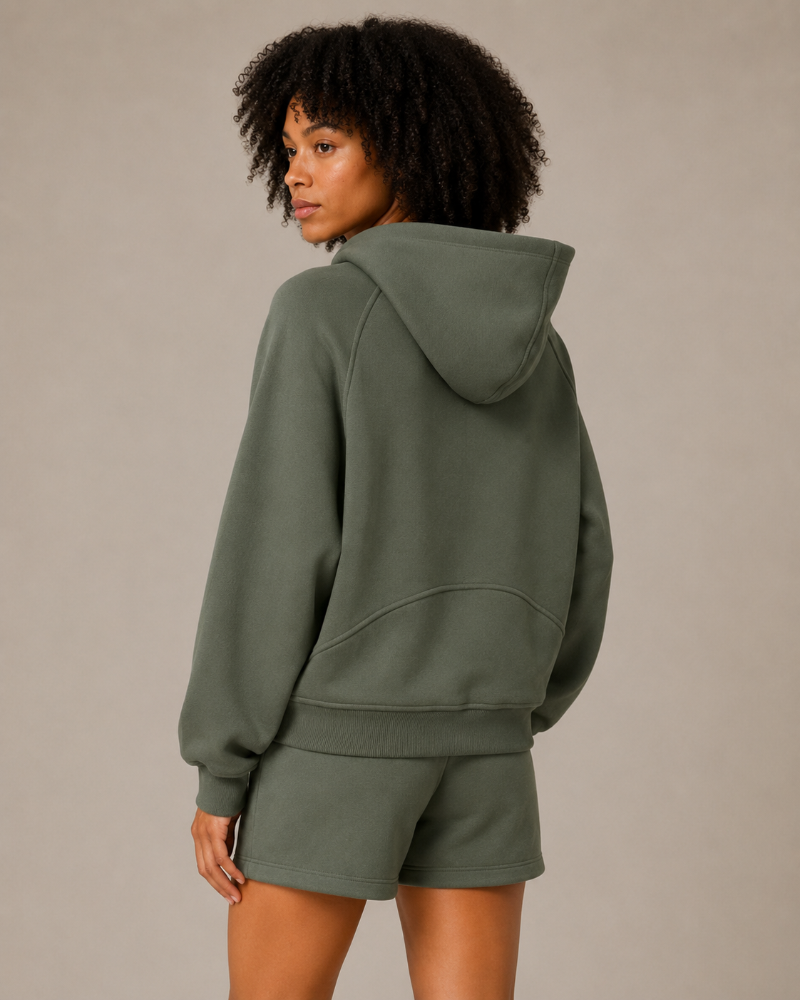 Rear angled view of the olive green Fitfigura Core Hoodie – Essential Form, highlighting the hood, sleeve shape, and relaxed back fit.