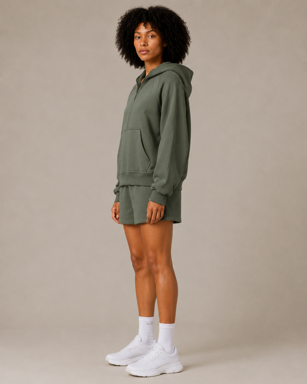 Side view of the Fitfigura Core Hoodie – Essential Form in olive green, showing the relaxed fit and casual activewear silhouette.