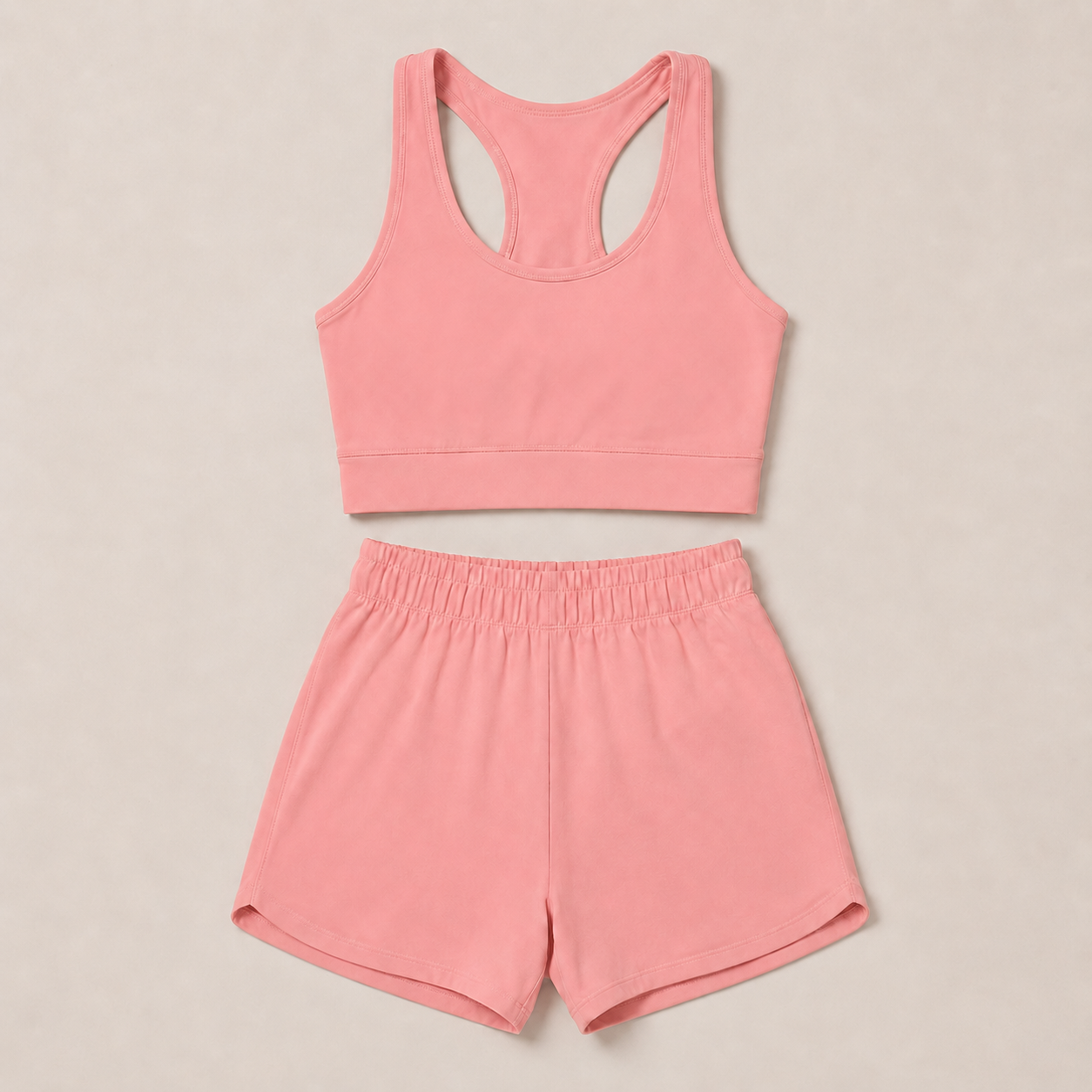 Flat lay of the Fitfigura Core Set – Minimal Sculpt Form in coral pink, featuring a sleeveless crop top and matching skirt.