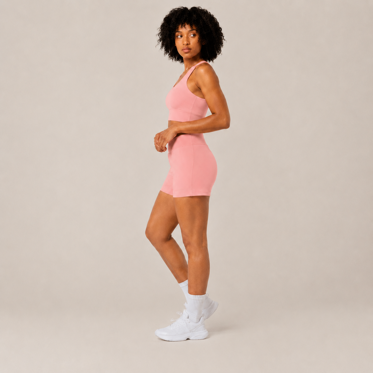 Side view of the Fitfigura Core Set – Minimal Sculpt Form in coral pink, showing the fitted crop top and sleek skirt shape.