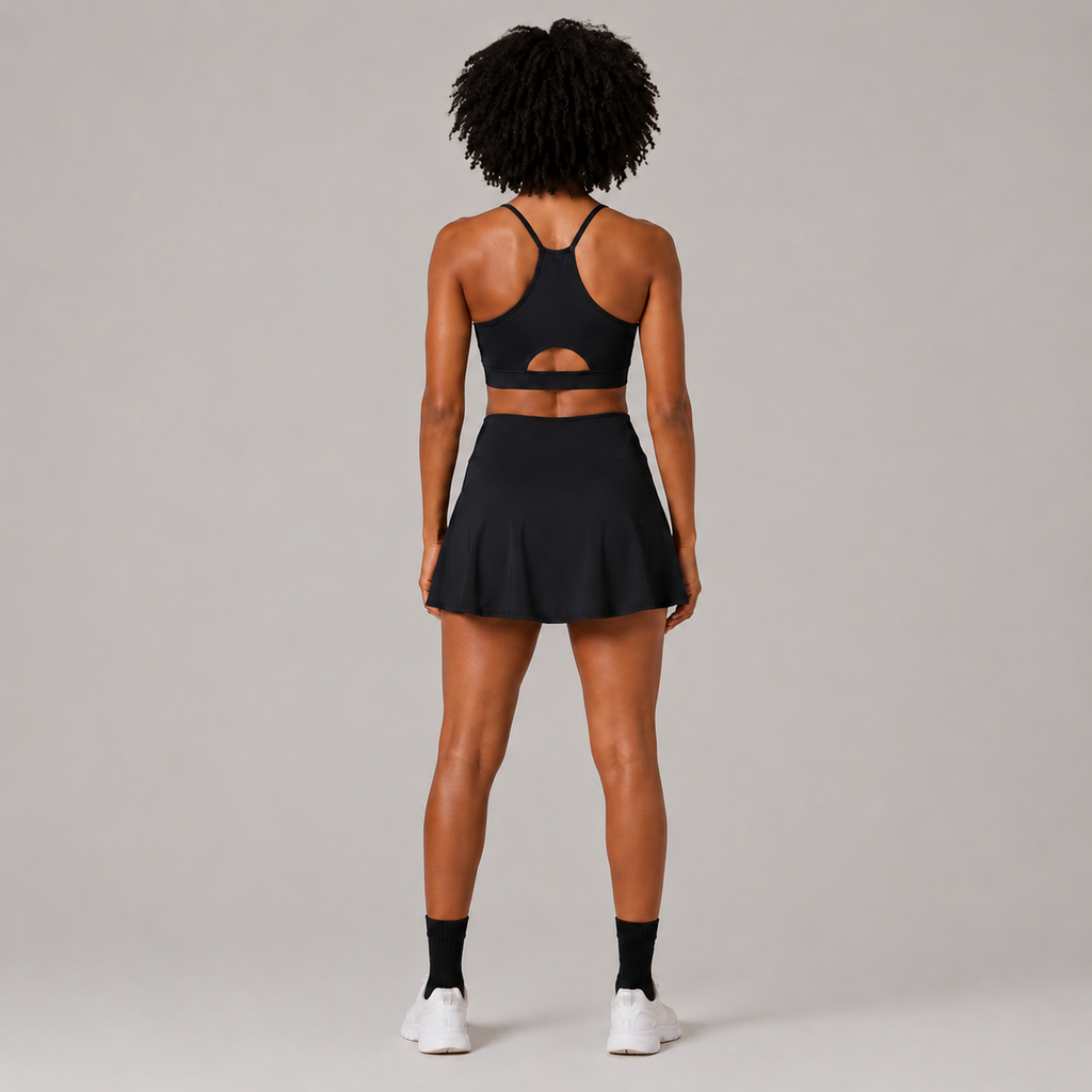 Back view of the Fitfigura Court Skirt – Classic Elite Form in black, showing the rear fit of the skirt and matching sports bra.