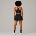Back view of the Fitfigura Court Skirt – Classic Elite Form in black, showing the rear fit of the skirt and matching sports bra.