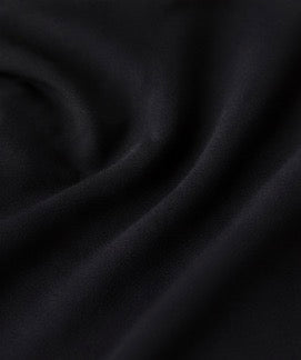 Close-up of the black fabric texture used in the Fitfigura Court Skirt – Classic Elite Form.