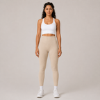 Model wearing the Fitfigura Flex Rib Legging in cream with a white crop top and white socks, shown from the front.