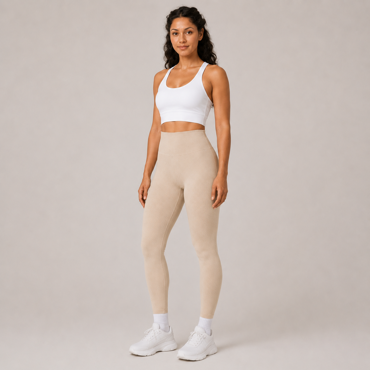 Full-body studio view of the cream Fitfigura Flex Rib Legging styled with a white crop top and white socks.