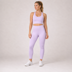Model wearing the Fitfigura Flow Performing Set – Soft Movement Form in light purple, featuring a sleeveless crop top and matching leggings, shown from the front