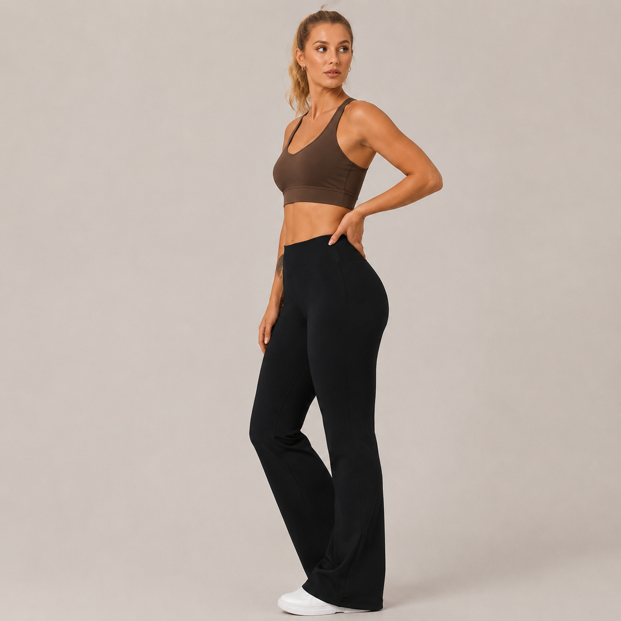 Side-angle view of the black Fitfigura Lounge Flare Pant – Relaxed Luxury Form, showing the fitted upper leg and relaxed flare silhouette.