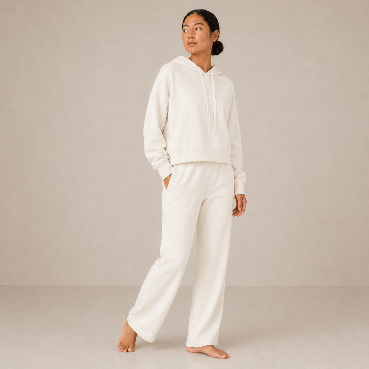 Side-angle view of the ivory Lounge Oversized Hoodie – Soft Form styled with matching wide-leg pants.