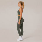 Side view of the Fitfigura Motion Bra – Sculpt Form in olive green, showing the cropped sports bra shape and smooth supportive fit.