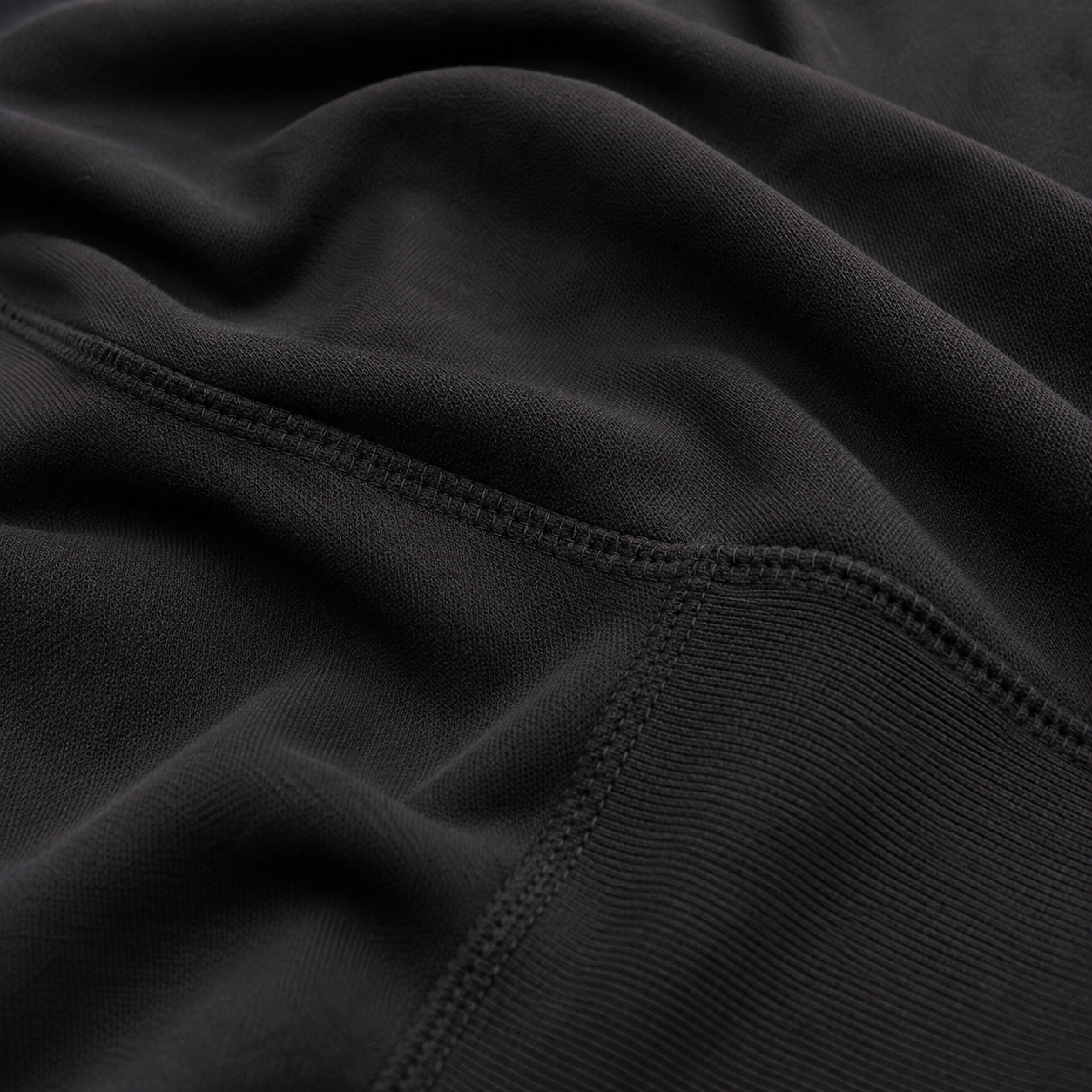 Close-up of the black fabric texture used in the Fitfigura Performance Hoodie – Active Form.