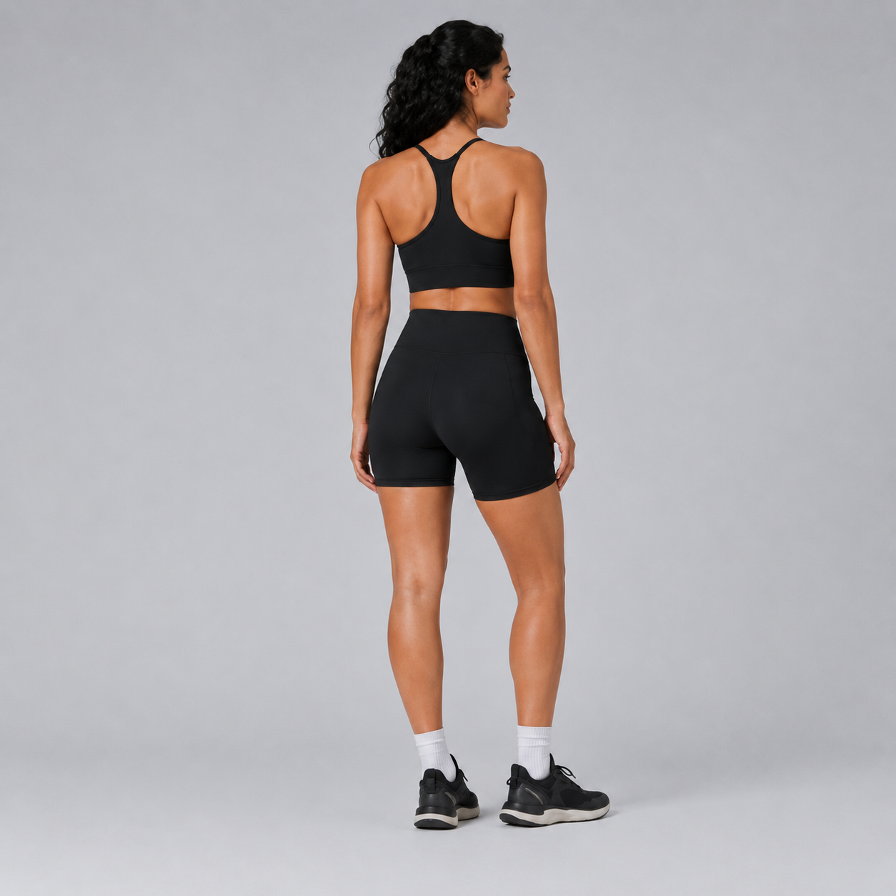 Back view of the black Fitfigura Pocket Short – Utility Performance Form, showing the high-rise waistband and smooth rear fit.