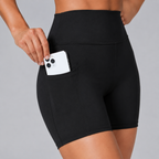 Close-up of the black Fitfigura Pocket Short – Utility Performance Form showing the side utility pocket with a phone.