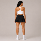 Back view of the Fitfigura Rally Tennis Skirt – Sculpt Court Form in black, showing the rear fit and pleated skirt shape.