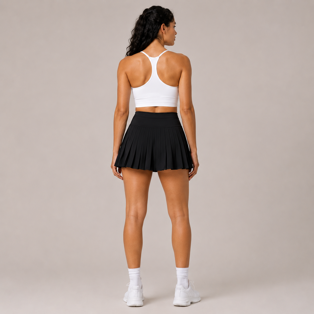 Back view of the Fitfigura Rally Tennis Skirt – Sculpt Court Form in black, showing the rear fit and pleated skirt shape.