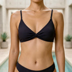Flat lay of the Fitfigura Rib Bikini – Texture Form in black, featuring the bikini top and matching bottoms arranged on a neutral background.