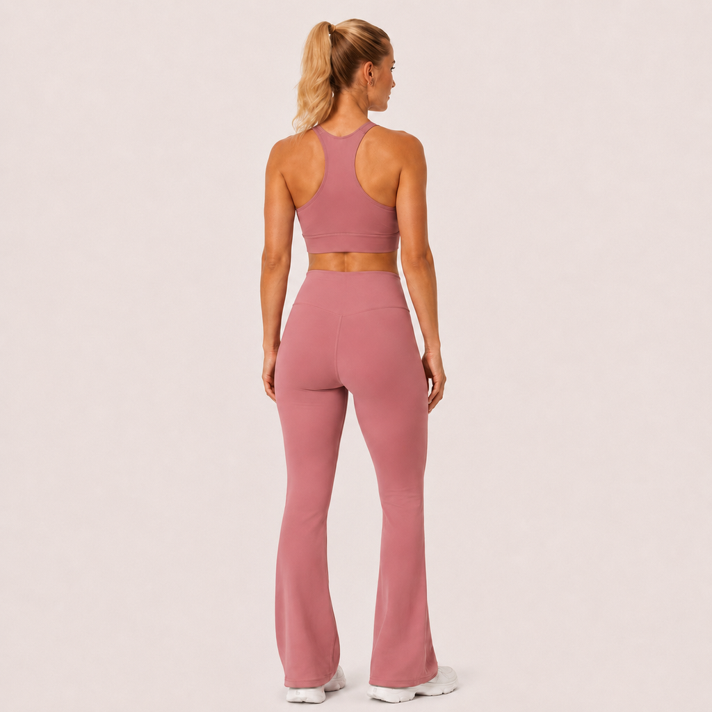 Back view of the dusty pink Fitfigura Rib Knit Flare Pant – Textured Luxe Form, showing the sculpted rear fit and full-length flare.