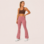 Model posing in the dusty pink Fitfigura Rib Knit Flare Pant – Textured Luxe Form, highlighting the rib knit texture and high-rise waistband.