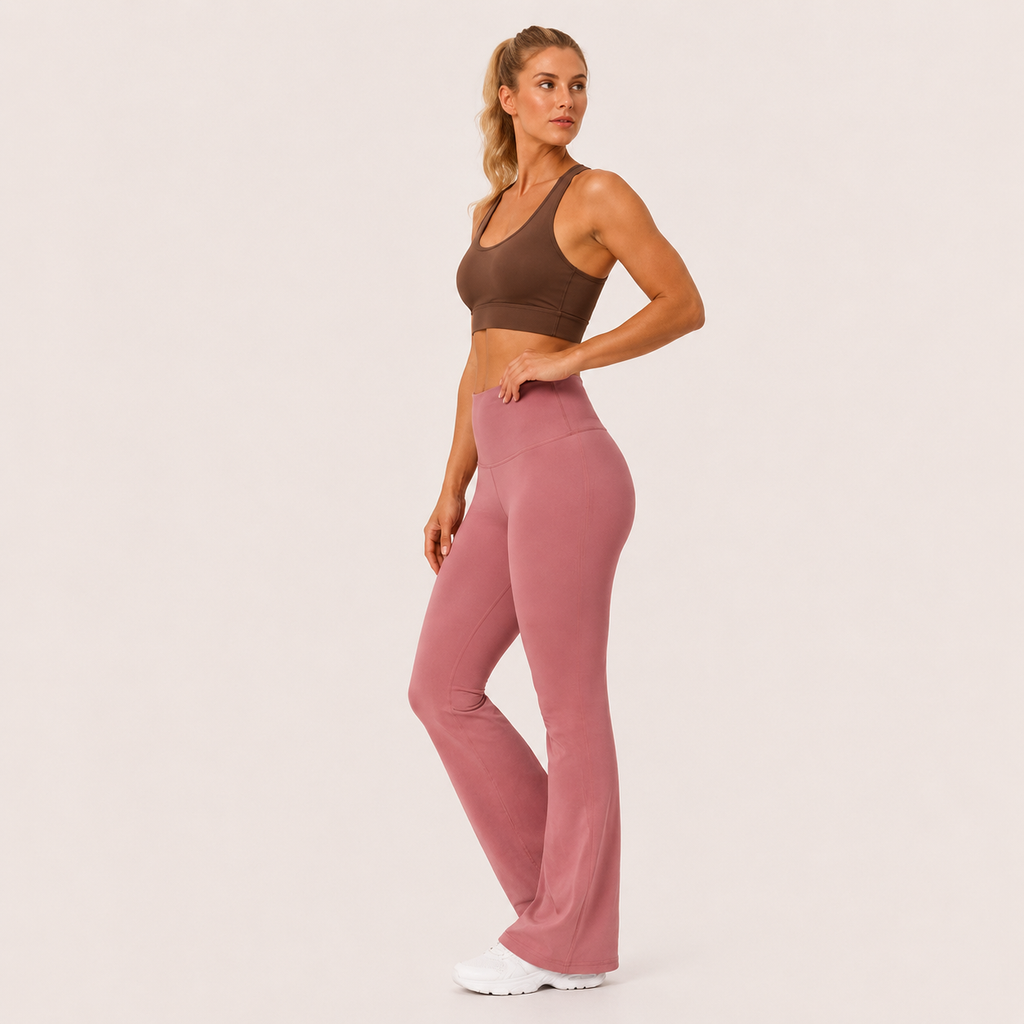 Side-angle view of the dusty pink Fitfigura Rib Knit Flare Pant – Textured Luxe Form, showing the fitted upper leg and soft flare silhouette.