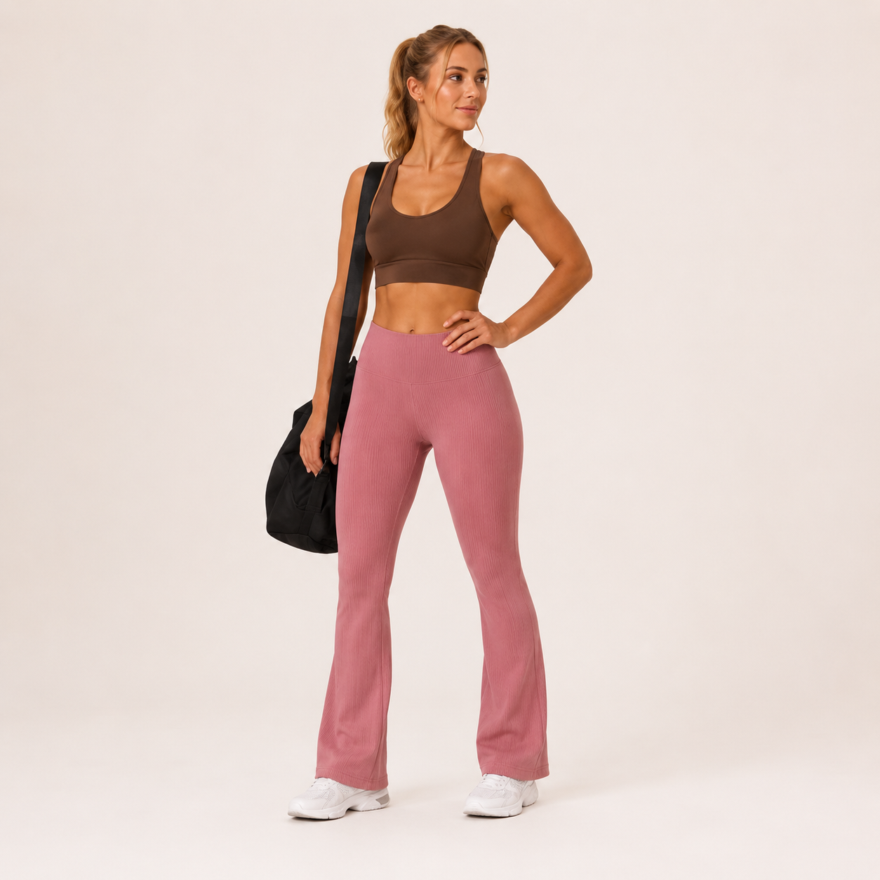 Full-body view of the dusty pink Fitfigura Rib Knit Flare Pant – Textured Luxe Form, showing the smooth fit through the hips and flared hemline.