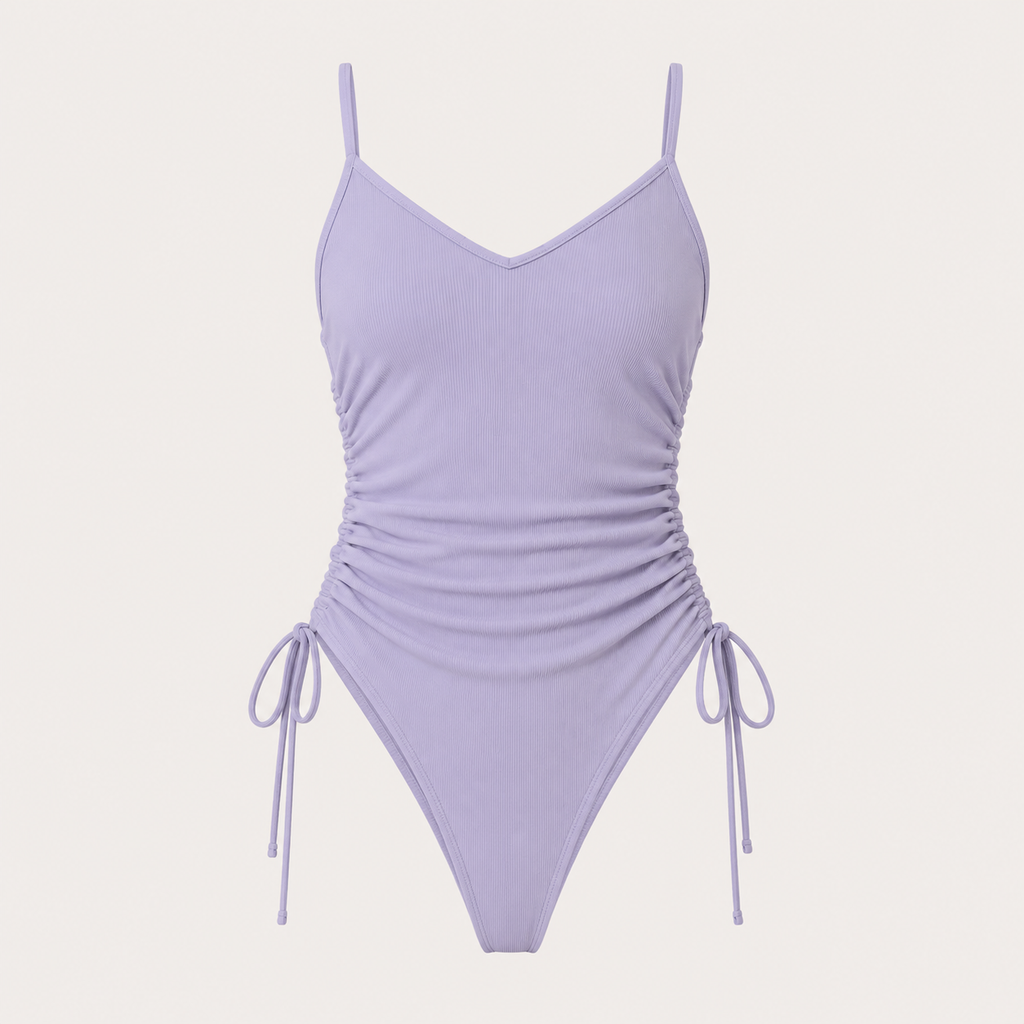 Flat lay of the Fitfigura Rib One-Piece – Texture Form in light purple, featuring thin straps, ruched sides, and adjustable tie details.