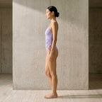 Full side profile of the Fitfigura Rib One-Piece – Texture Form in light purple, showing the streamlined one-piece shape.