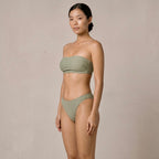 Three-quarter studio view of the sage green Fitfigura Sculpt Bikini – Contour Form, showing the bandeau top and matching bikini bottoms.