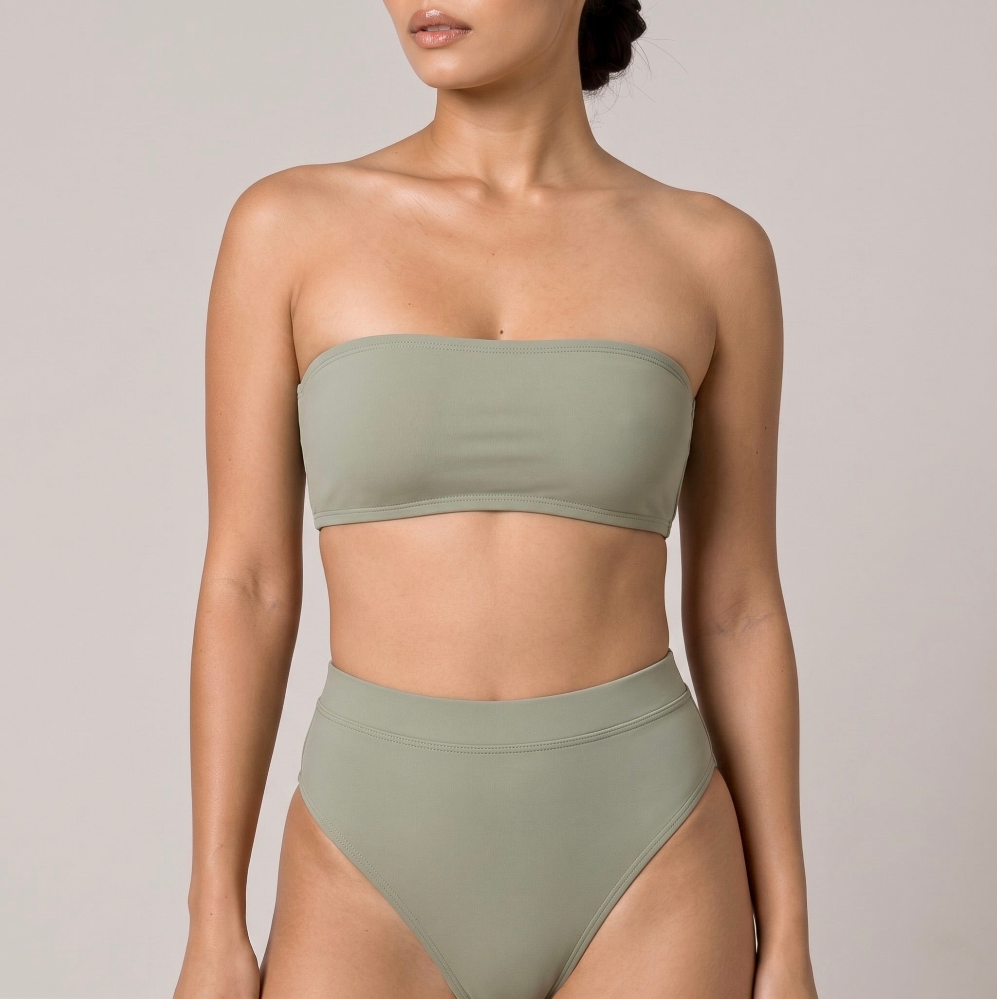 Close-up of the sage green Fitfigura Sculpt Bikini – Contour Form showing the bandeau neckline and smooth sculpted finish of the bikini top.