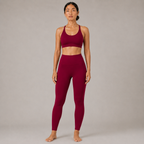 Model wearing the Fitfigura Sculpt Butterlift Leggings in burgundy with a matching sports bra, shown from the front.