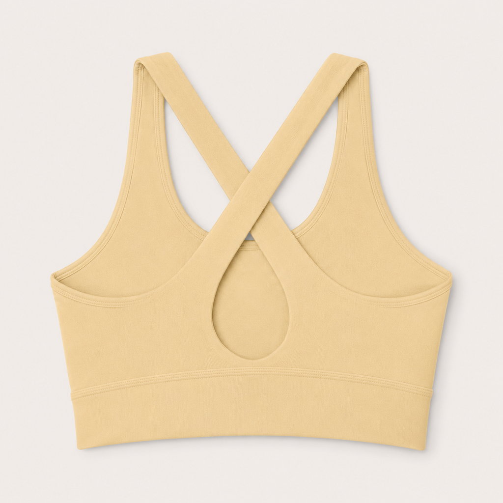 Flat lay back view of the Fitfigura Sculpt Set – Seamless Form sports bra in butter yellow, showing the crisscross strap detail and keyhole cutout.