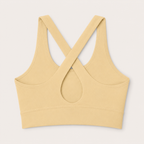 Flat lay back view of the Fitfigura Sculpt Set – Seamless Form sports bra in butter yellow, showing the crisscross strap detail and keyhole cutout.