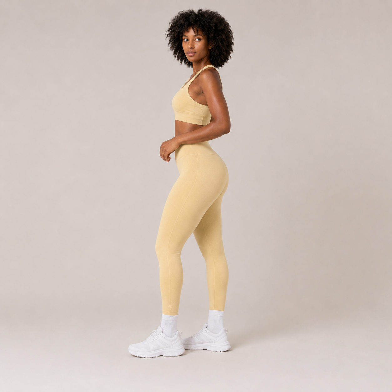 Side view of the Fitfigura Sculpt Set – Seamless Form in butter yellow, highlighting the smooth seamless fit and high-rise leggings.