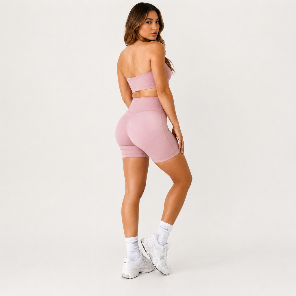 Angled studio view of the light pink Fitfigura Sculpt Short 6” – Performance Sculpt Form, highlighting the fitted waistband and sculpted silhouette.