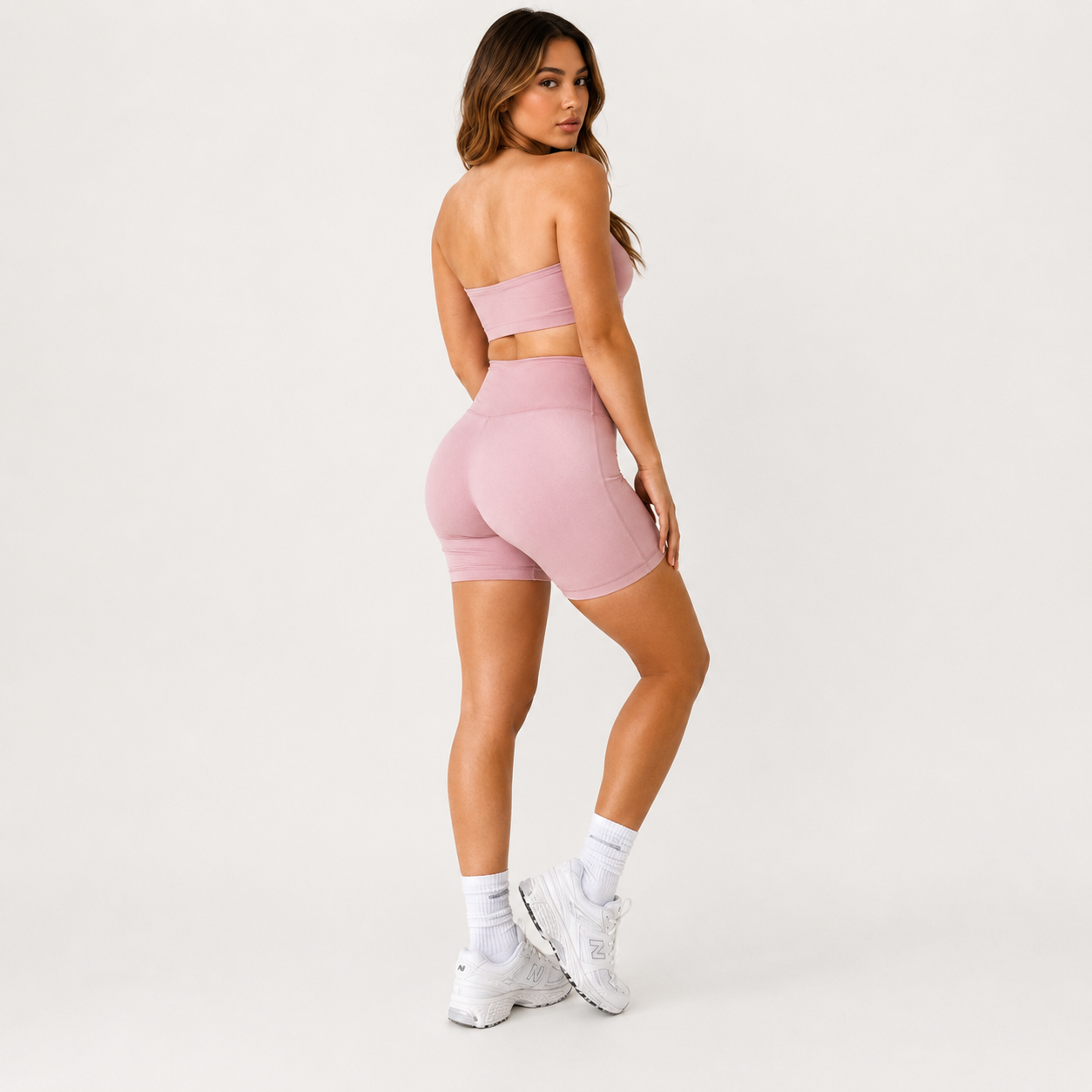 Angled studio view of the light pink Fitfigura Sculpt Short 6” – Performance Sculpt Form, highlighting the fitted waistband and sculpted silhouette.