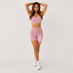 Model posing in the light pink Fitfigura Sculpt Short 6” – Performance Sculpt Form with arms raised, highlighting the high-waisted fit and sculpting short length.