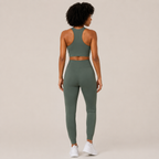 Back view of the Fitfigura Seamless Set – Performance Sculpt Form in sage green, showing the racerback crop top and high-rise leggings.