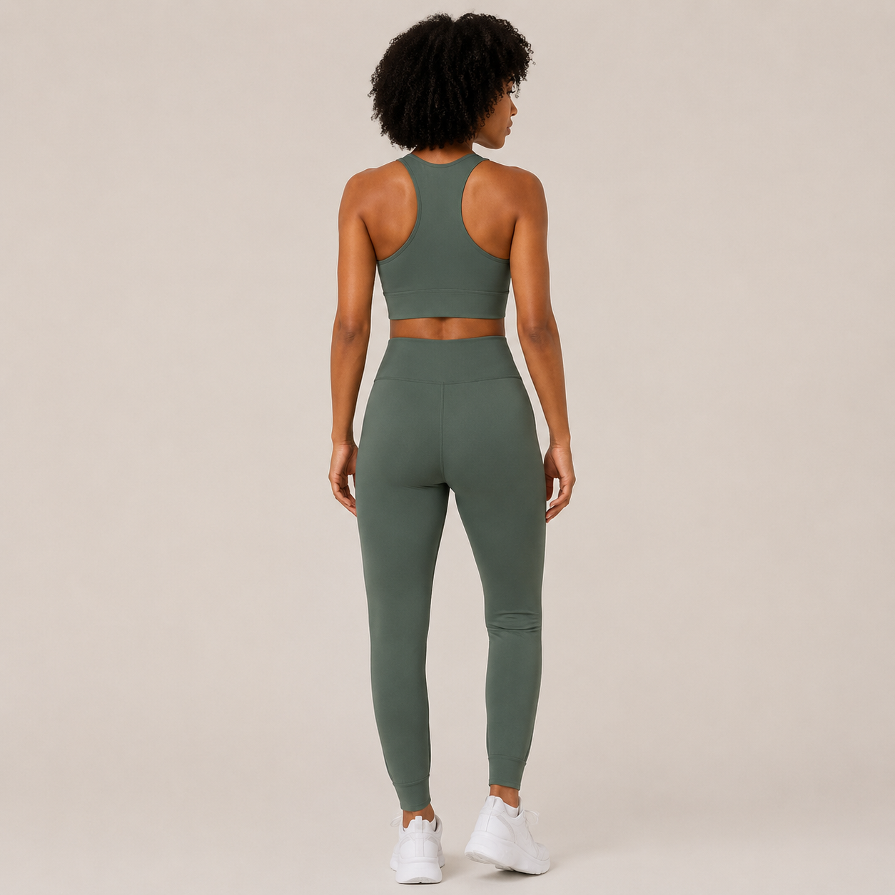 Back view of the Fitfigura Seamless Set – Performance Sculpt Form in sage green, showing the racerback crop top and high-rise leggings.